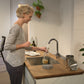 woman filling bottle with hansgrohe kitchen sink mixer